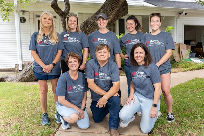 Caring Transitions staff standing in front of a client's home.